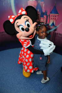 Kasey Abraham hugs Minnie Mouse