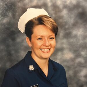 Jacqueline wears a blue nurse uniform