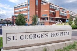 A photo of St George's Hospital behind a huge sign that says St George's Hospital