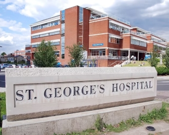 A photo of St George's Hospital behind a huge sign that says St George's Hospital