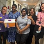 Five women at St George's Hospital holding one of the packs