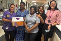 Five women at St George's Hospital holding one of the packs