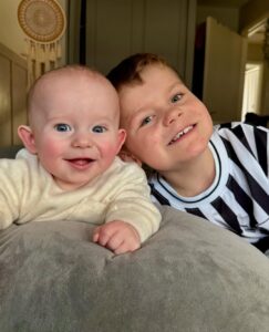 Baby Louis and Jackson smile into a camera