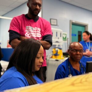 To colleagues using the new electronic patient records system as a third colleague supervises