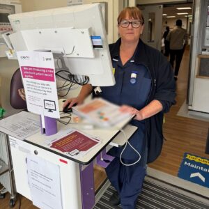 A staff member using the new electronic patient records system at a work station