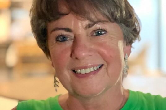 Jacqueline wears a green top
