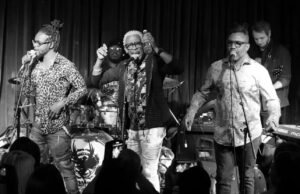 The British Collective singing on stage