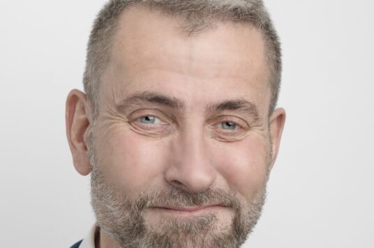 Dr Jennings in a blue jacket and white shirt